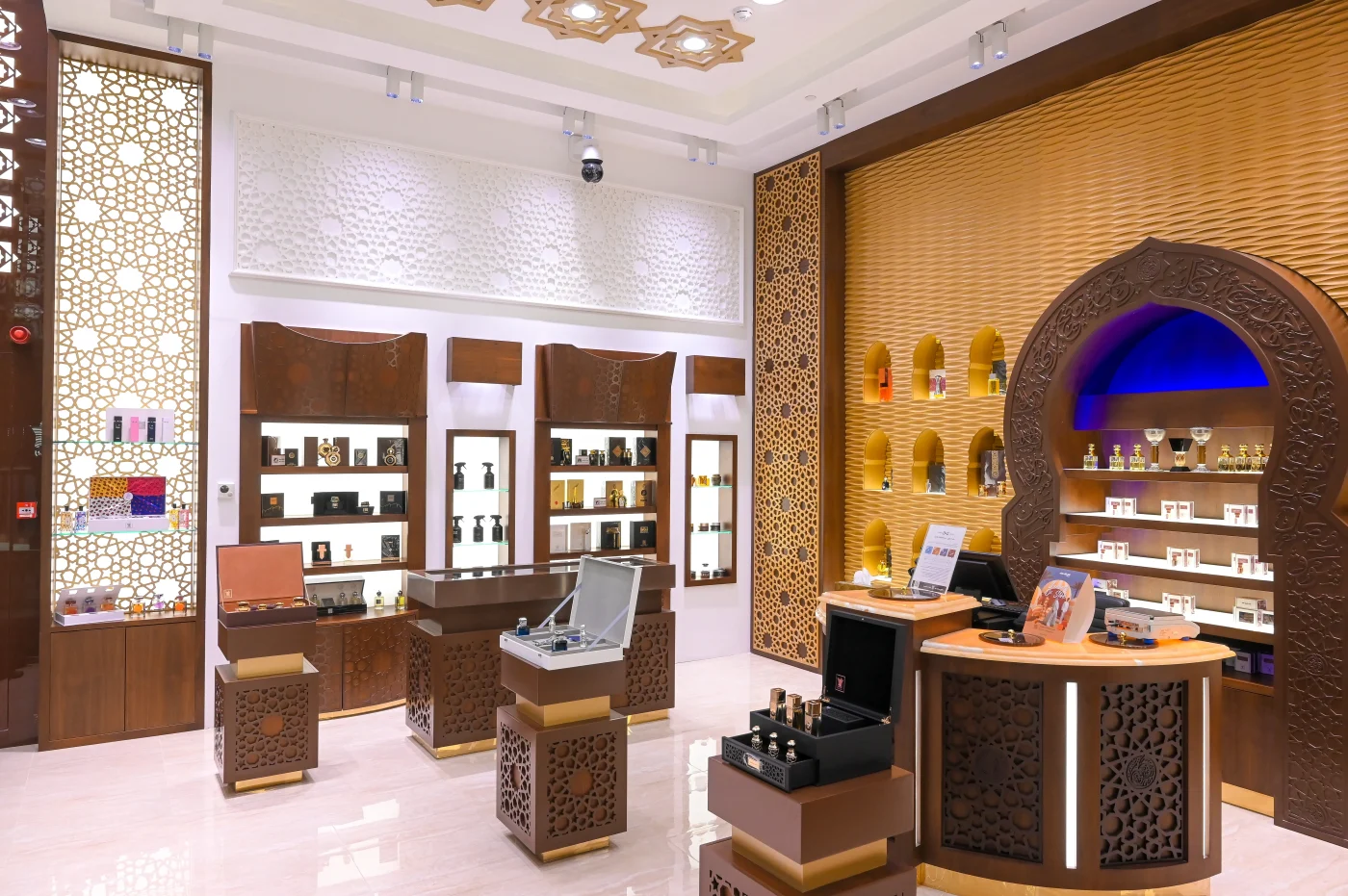 Arabian Oud perfume display interior design Dubai - UMI Group luxury retail space featuring custom perfume showcases, premium lighting design, and sophisticated Arabian-inspired decor elements